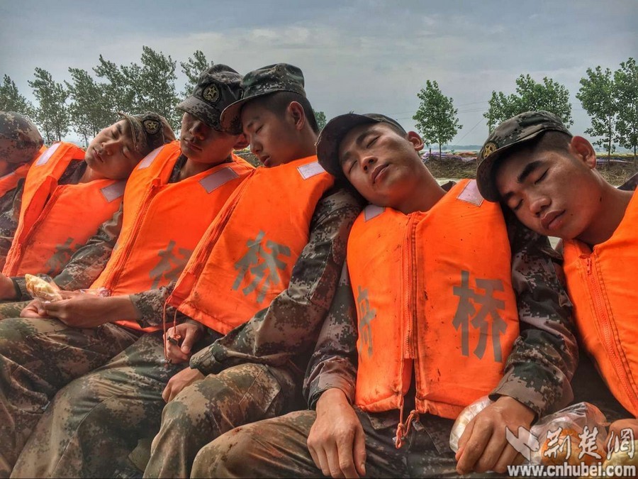 连续奋战25小时 舟桥旅官兵拿着面包睡着了